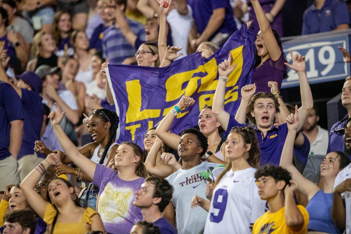 LSU football fans hold up an LSU Tigers sign while cheering on Saturday, Sept. 24, 2022, during the LSU vs New Mexico game in Tiger Stadium.