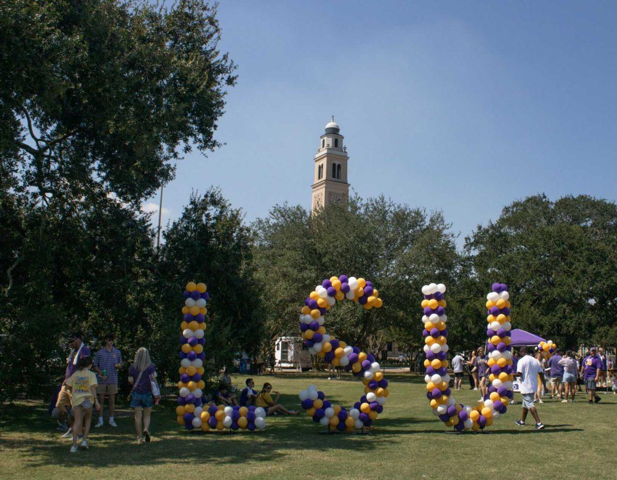 Visitors walk around an LSU balloon sign at the LSU Family Weekend Tailgate on Saturday, Sept. 24, 2022, on the LSU Parade Ground in Baton Rouge, La.