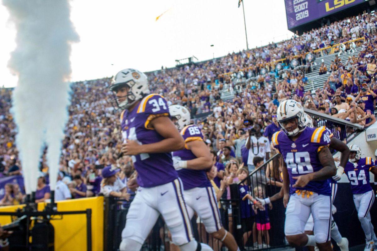 Smoke blows as the LSU football team runs out onto the field on Saturday, Sept. 24, 2022, right before the LSU vs New Mexico game in Tiger Stadium.