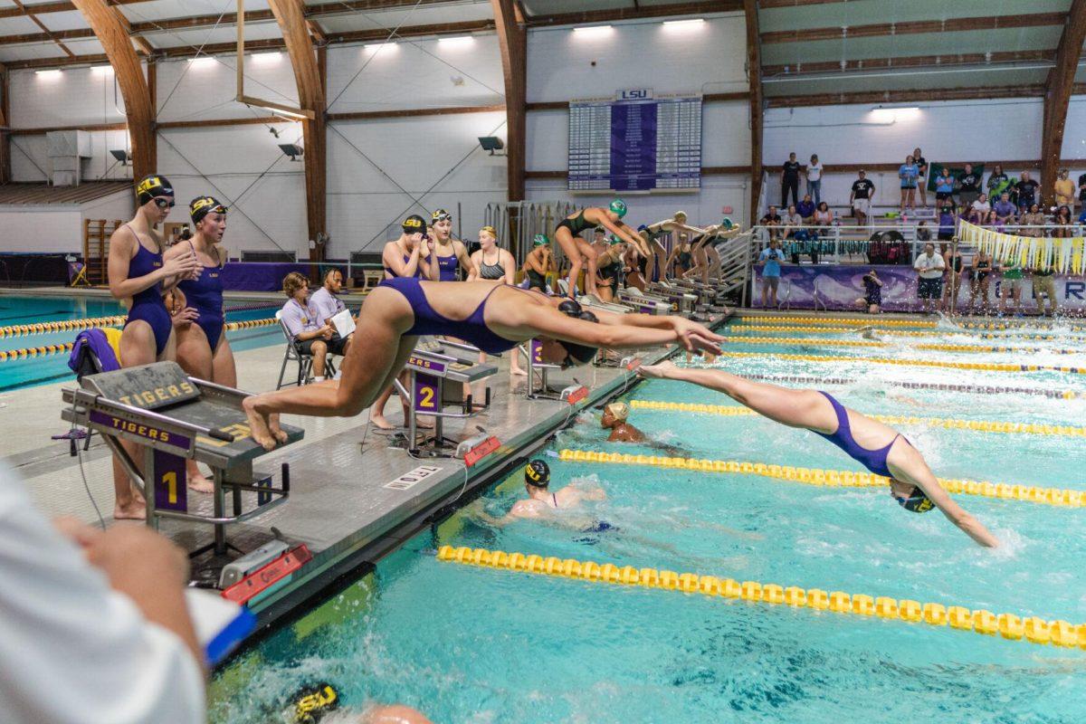 LSU swimmers dive into the pool on Friday, Sept. 23, 2022, for the 400-yard freestyle relay during LSU&#8217;s victory over Tulane and Vanderbilt at the LSU Natatorium on Nicholson Drive in Baton Rouge, La.