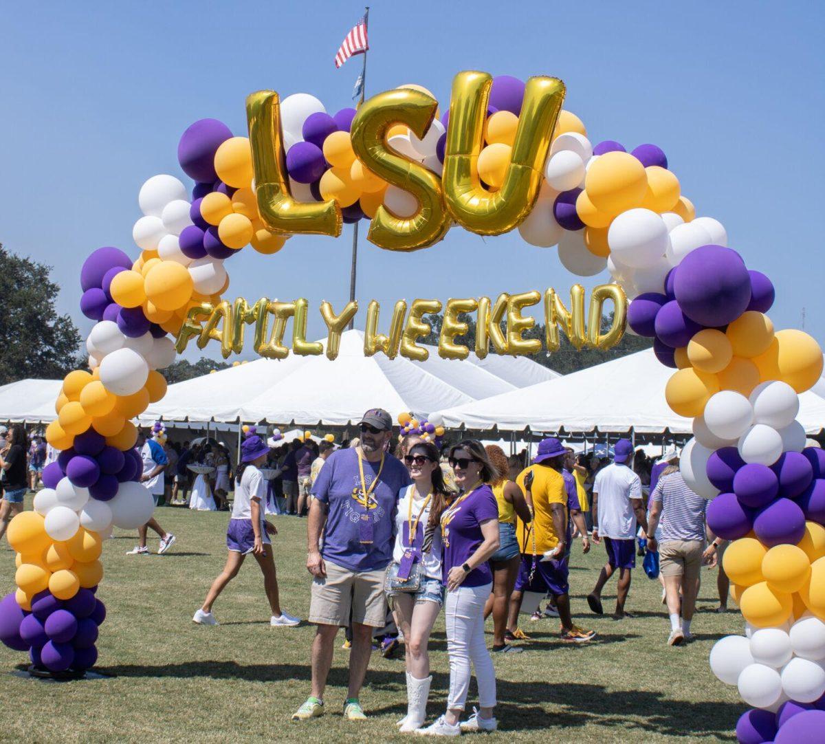 A family poses for a picture under a balloon arch at the LSU Family Weekend Tailgate on Saturday, Sept. 24, 2022, on the LSU Parade Ground in Baton Rouge, La.