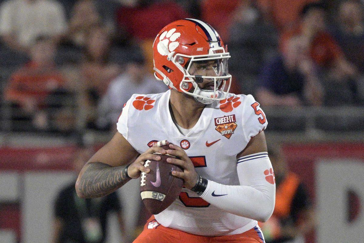 Clemson quarterback D.J. Uiagalelei (5) looks for a receiver during the second half of the Cheez-It Bowl NCAA college football game against Iowa State, Wednesday, Dec. 29, 2021, in Orlando, Fla. Veteran quarterbacks are plentiful in the Atlantic Coast Conference this season. In all, 12 of the 14 league teams have at least one quarterback with nine or more career starts. (AP Photo/Phelan M. Ebenhack)