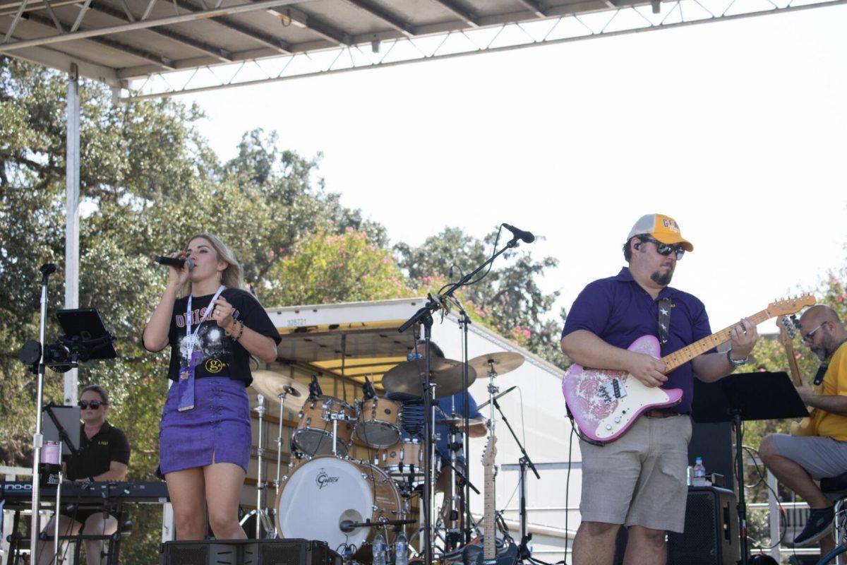 A singer and a guitarist perform on stage at the LSU Family Weekend Tailgate on Saturday, Sept. 24, 2022, on the LSU Parade Ground in Baton Rouge, La.