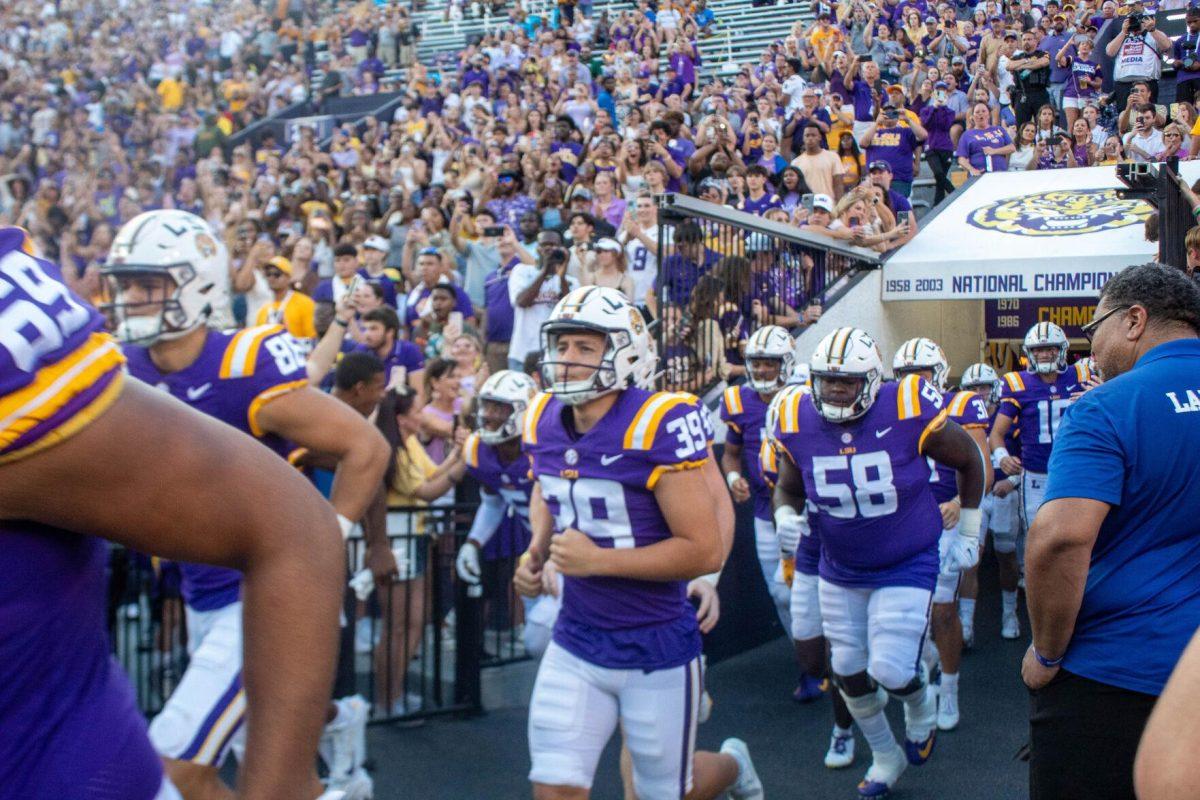 The LSU football team runs out onto the field on Saturday, Sept. 24, 2022, right before the LSU vs New Mexico game in Tiger Stadium.