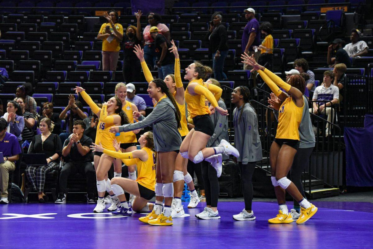 LSU volleyball teammates cheer on the team on Wednesday, Sept. 21, 2022, during LSU&#8217;s 3-2 win over Arkansas at the Pete Maravich Assembly Center in Baton Rouge, La.