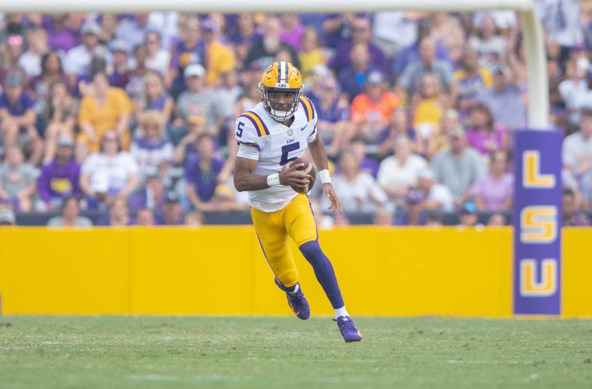 LSU football junior quarterback Jayden Daniels (5) rushes down the field to achieve a first down on Saturday, Sept. 17, 2022, during LSU&#8217;s 31-16 win against Mississippi State in Tiger Stadium in Baton Rouge, La.