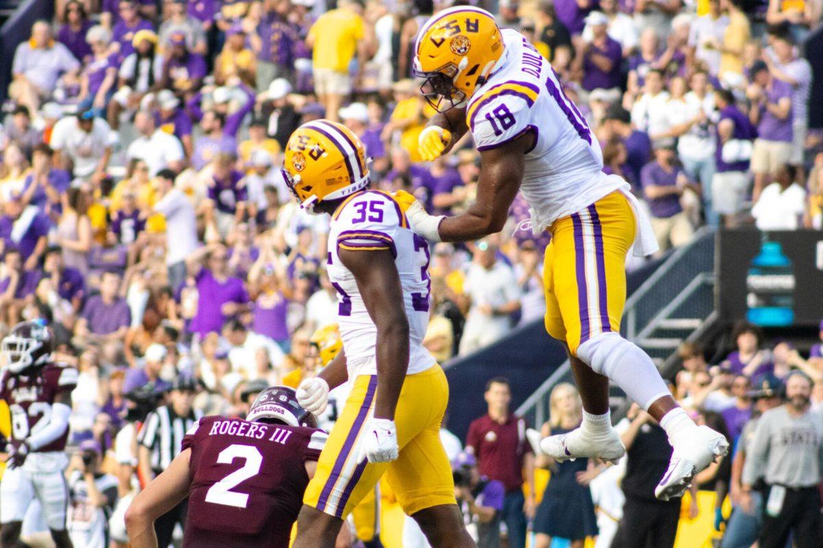 LSU football junior defensive end BJ Ojulari (18) leaps onto sophomore defensive end Sai’vion Jones’s back as they celebrate a Mississippi State fumble Saturday, Sept. 17, 2022 during LSU’s 31-16 win against Mississippi State at Tiger Stadium in Baton Rouge, La.