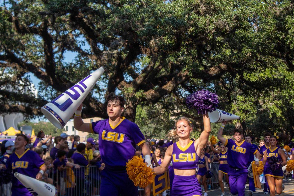 LSU Cheerleaders hype up fans while they run down Victory Hill on Saturday, Sept. 24, 2022, prior to the LSU vs New Mexico game in Tiger Stadium.