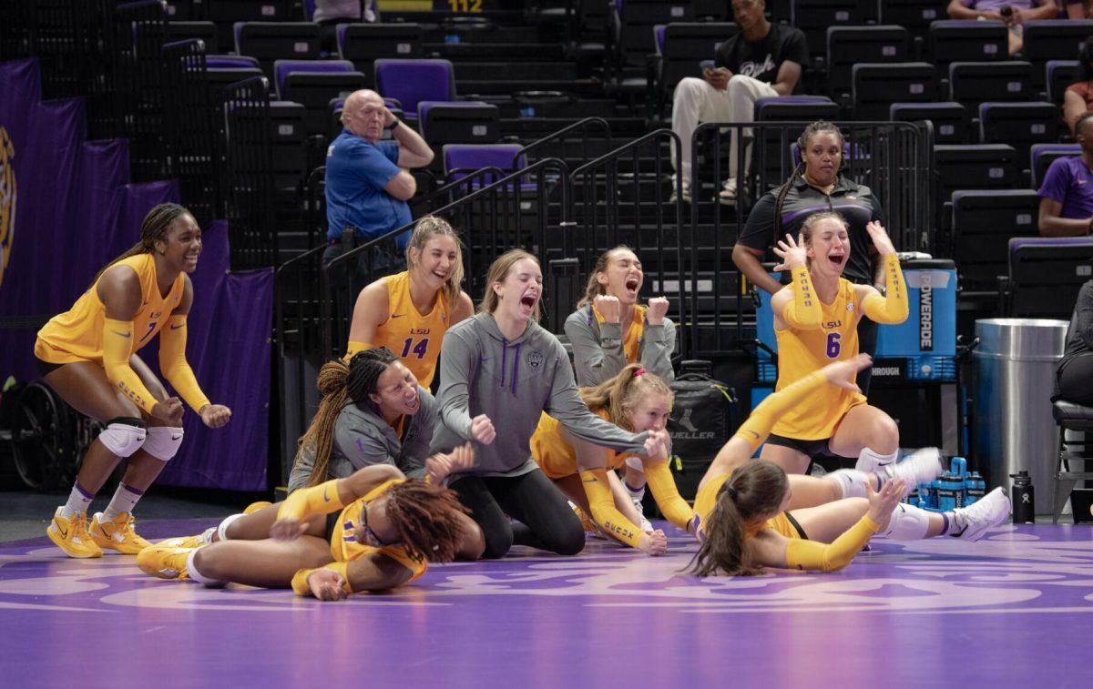 The LSU volleyball team falls to the floor in excitement on Friday, Sept. 2, 2022, during LSU&#8217;s 3-0 victory over Iowa State in the Pete Maravich Assembly Center in Baton Rouge, La.