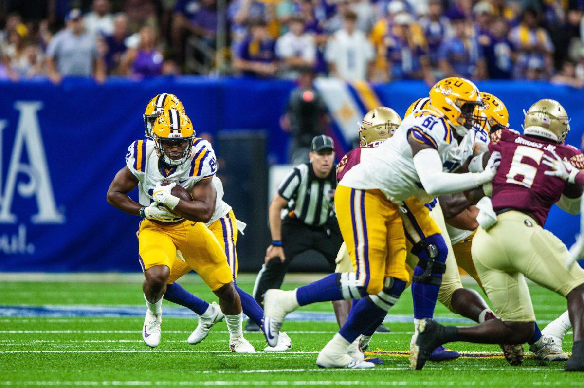 LSU football junior running back Noah Cain (21) finds a gap in the Florida State defense Sunday, Sept. 4, 2022, during LSU's Allstate Kickoff game defeat to Florida State 23-24 in the Caesars Superdome, New Orleans, La.