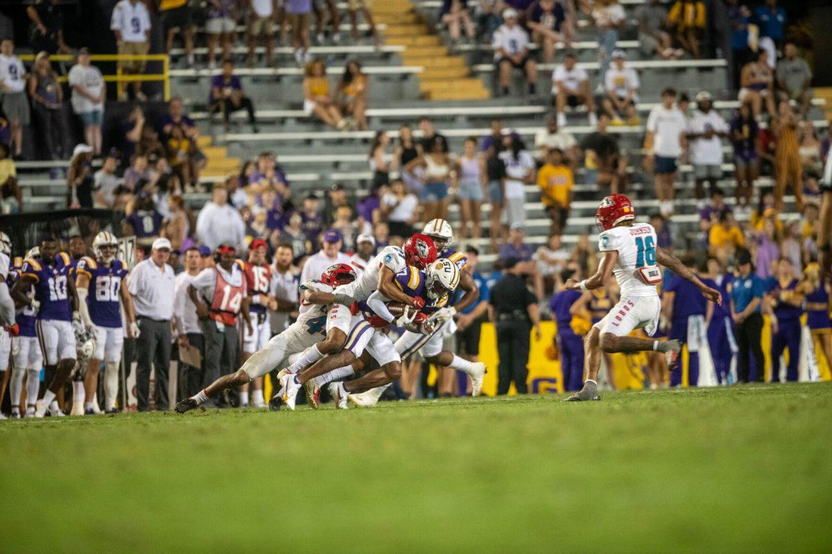 LSU football freshman wide receiver Chris Hilton Jr. (17) gets tackled by two New Mexico players after catching the ball on Saturday, Sept. 24, 2022, during the LSU vs New Mexico game in Tiger Stadium&#160;in Baton Rouge, La.