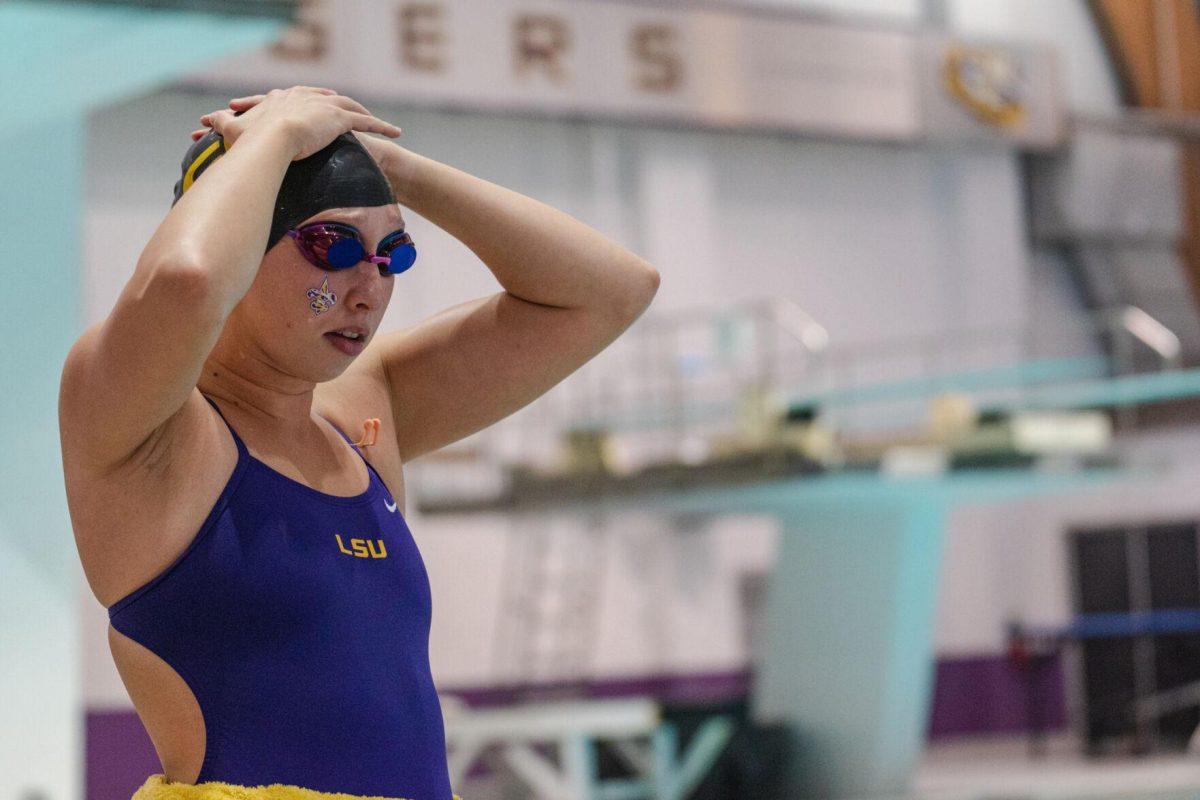 LSU swim sprint freestyle Peyton Curry adjusts her swim cap on Friday, Sept. 23, 2022, during LSU&#8217;s victory over Tulane and Vanderbilt at the LSU Natatorium on Nicholson Drive in Baton Rouge, La.