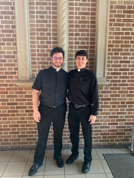 Priests Mathew Dunn, left, and Andrew Merrick, right, pose together at Christ the King Church.