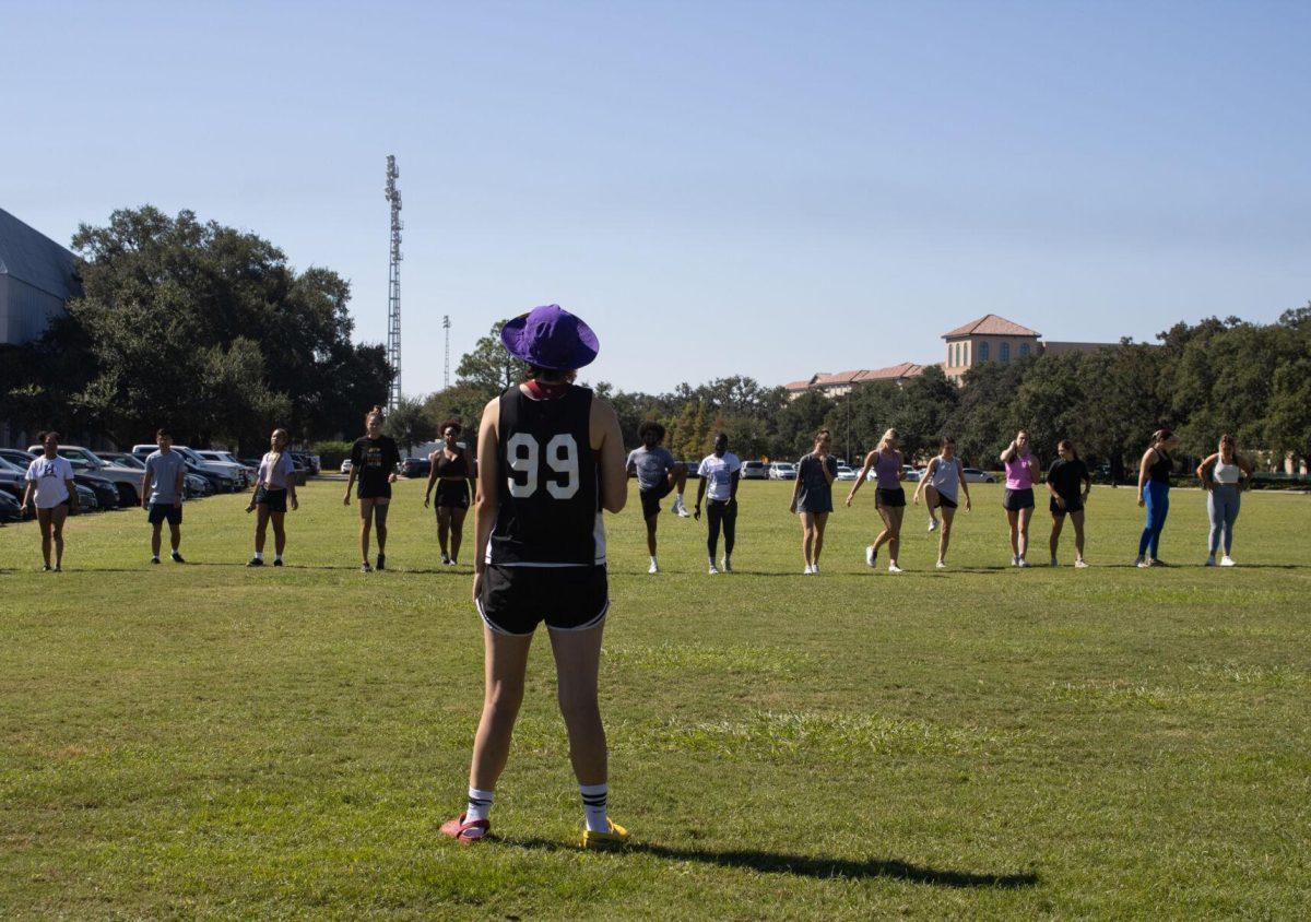 The instructor looks on as her jogging class completes warmups on Wednesday, Sept. 14, 2022, at the field by the LSU Natatorium in Baton Rouge, La.