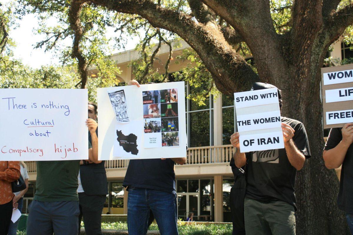 Advocates in Free Speech Alley wear masks, sunglasses and cover their faces with signs to protect their identity to avoid being recognized by the Iranian government, said a protester on Sept. 23, 2022.