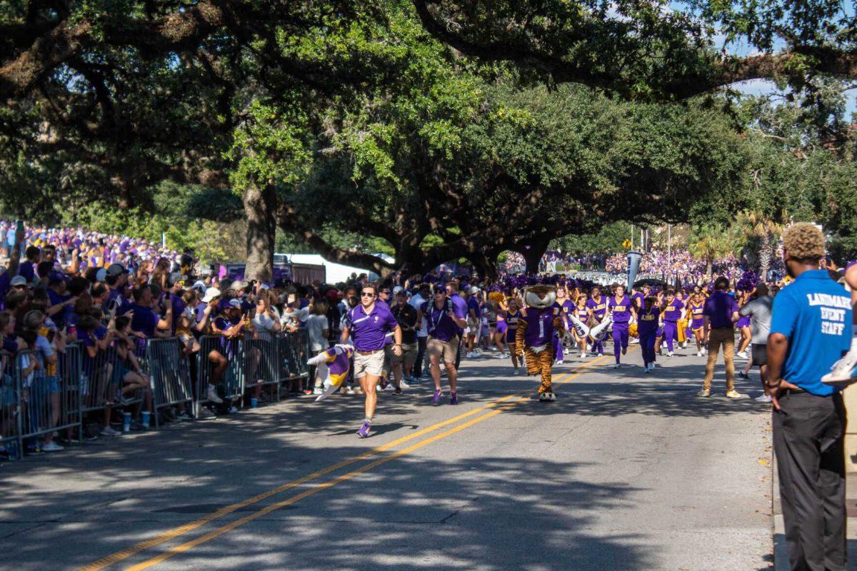 Mike the Tiger and LSU cheerleaders run down Victory Hill together on Saturday, Sept. 24, 2022, prior to the LSU vs New Mexico game on North Stadium Drive.