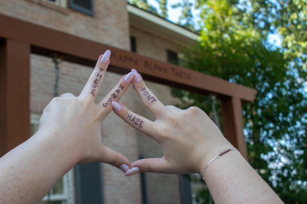 Junior LSU student Laine Cohen's hands hold up sorority hand sign in front of the sorority house on Thursday, Sept. 22, 2022 on W Lakeshore Drive in Baton Rouge.