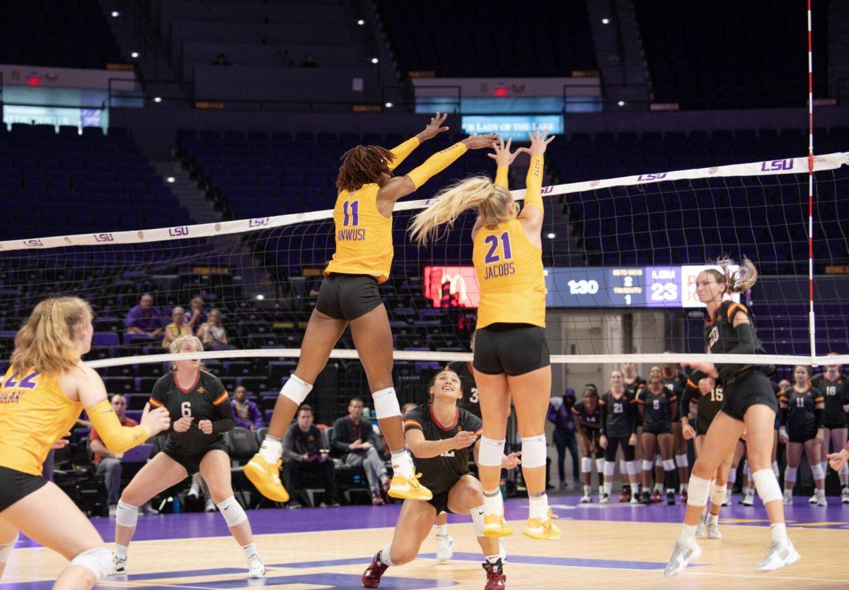 LSU volleyball senior middle blocker Anita Anwusi (11) and LSU volleyball graduate student right side/outside hitter Hannah Jacobs (21) successfully block the ball on Friday, Sept. 2, 2022, during LSU&#8217;s 3-0 victory over Iowa State in the Pete Maravich Assembly Center in Baton Rouge, La.