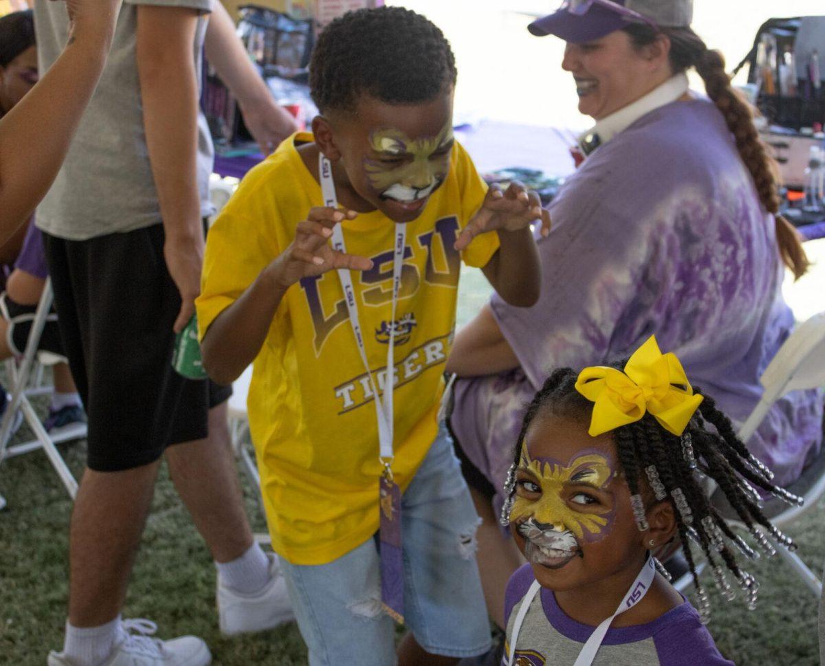 A girl and boy with tiger face paint enjoy themselves at the LSU Family Weekend Tailgate on Saturday, Sept. 24, 2022, on the LSU Parade Ground in Baton Rouge, La.