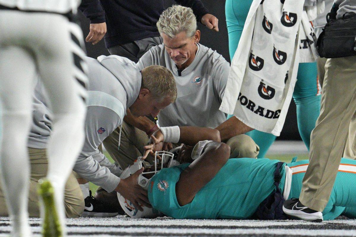 Miami Dolphins quarterback Tua Tagovailoa is examined during the first half of the team's NFL football game against the Cincinnati Bengals, Thursday, Sept. 29, 2022, in Cincinnati. (AP Photo/Jeff Dean)