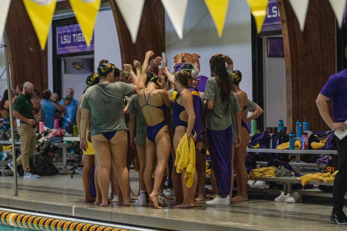 The LSU swim team huddles up on Friday, Sept. 23, 2022, prior to LSU&#8217;s victory over Tulane and Vanderbilt at the LSU Natatorium on Nicholson Drive in Baton Rouge, La.