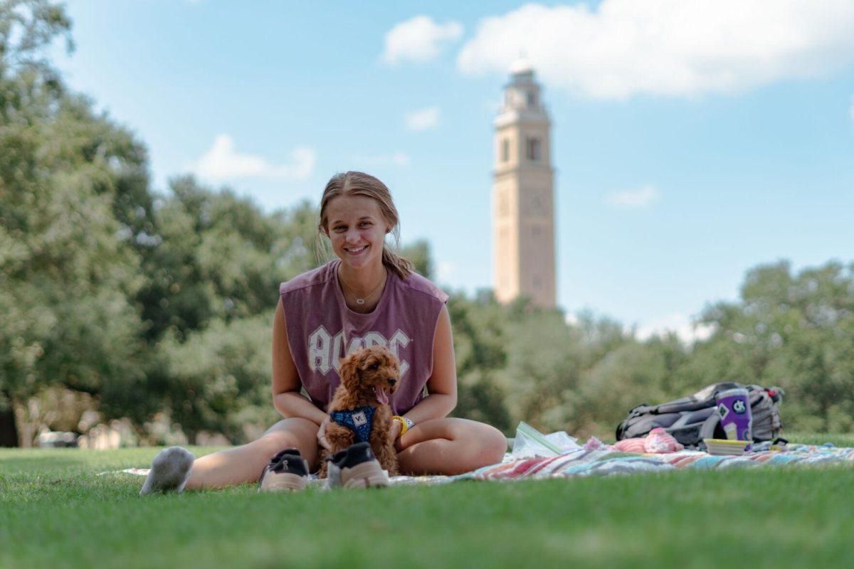 LSU kinesiology senior Caitlin Mathes and her dog Cooper pose for a photo on Friday, Sept. 9, 2022, on the Parade Ground on Highland Road in Baton Rouge, La.