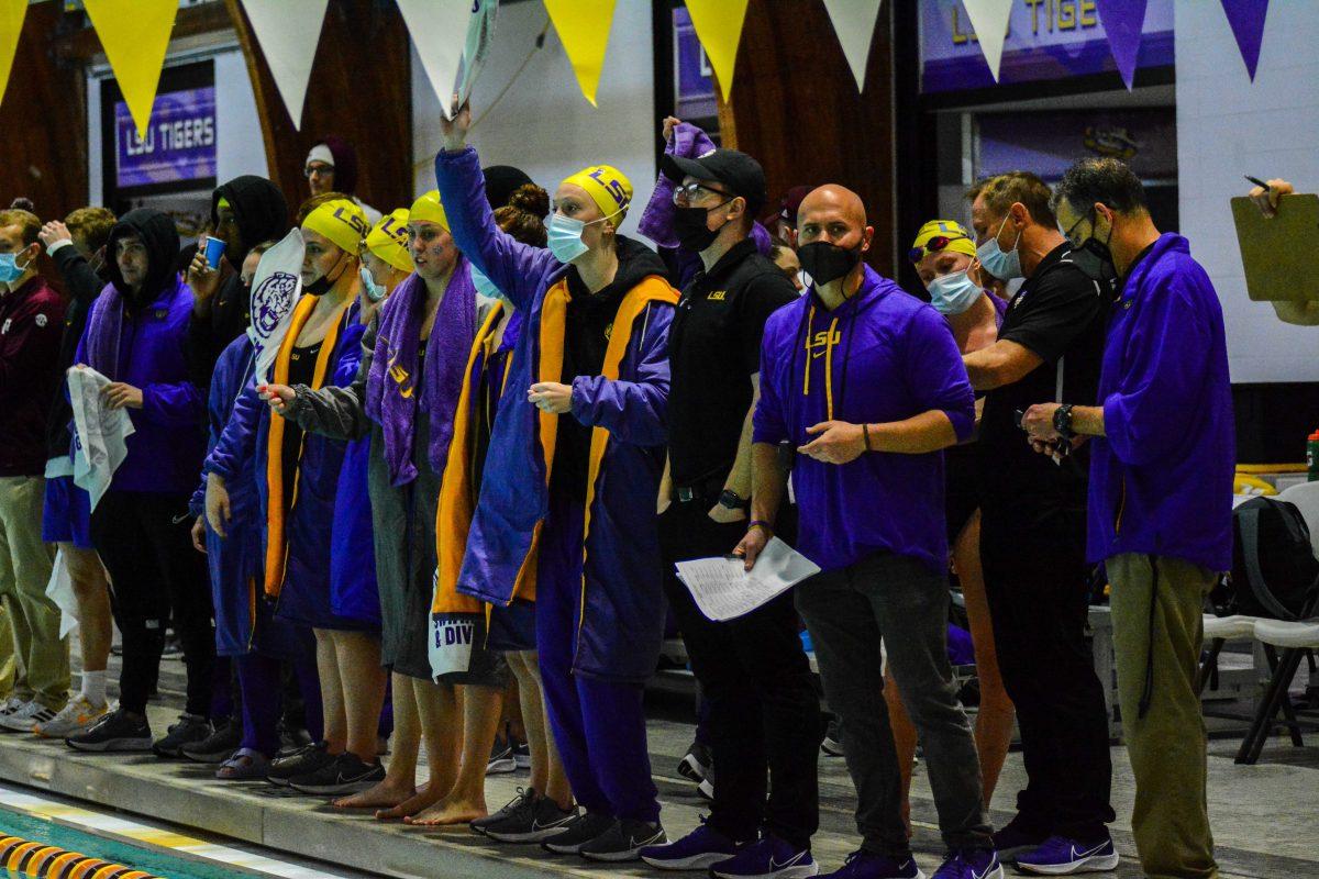 LSU swim and diving team cheer on their teammates Saturday, Jan. 22, 2022, during LSU men's 146-154 loss against Texas A&amp;M at the LSU Natatorium in Baton Rouge, La.