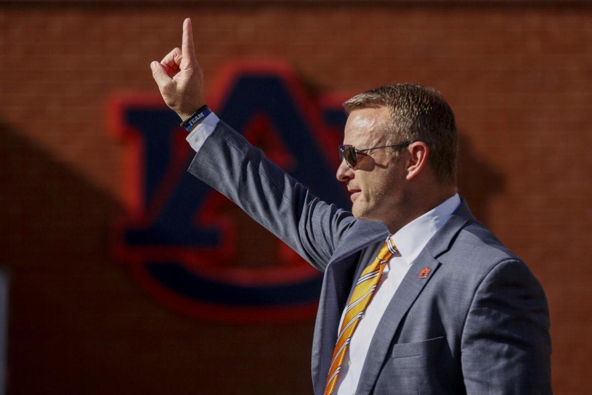 Auburn head coach Bryan Harsin waves to fans as he walks the field before the start of an NCAA college football game between Auburn and Missouri Saturday, Sept. 24, 2022 in Auburn, Ala. (AP Photo/Butch Dill)