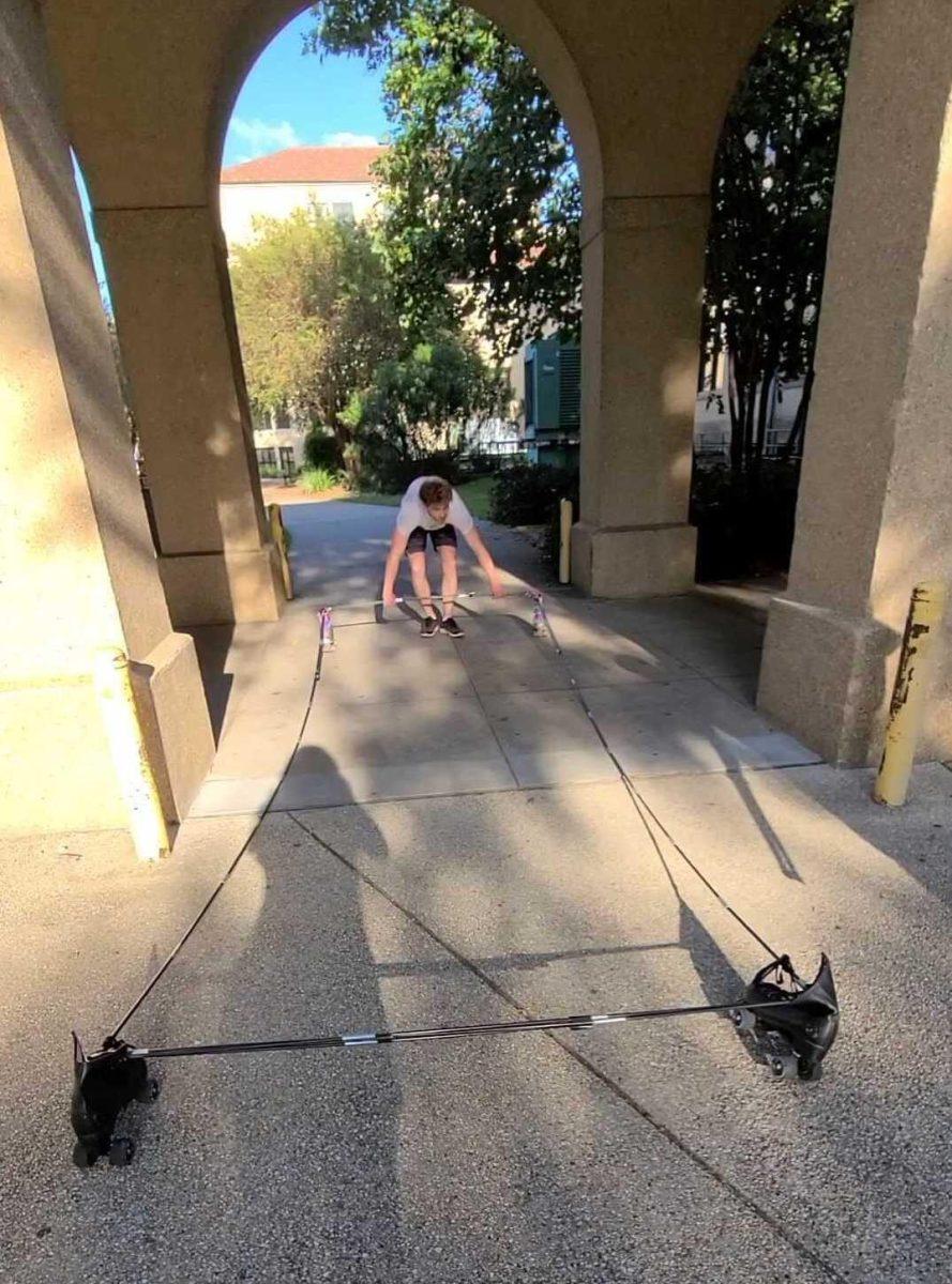 Will Nickel drags his "quad car" model through the entrance between Nicholson Hall and Coates Hall on Monday, Sept. 12.