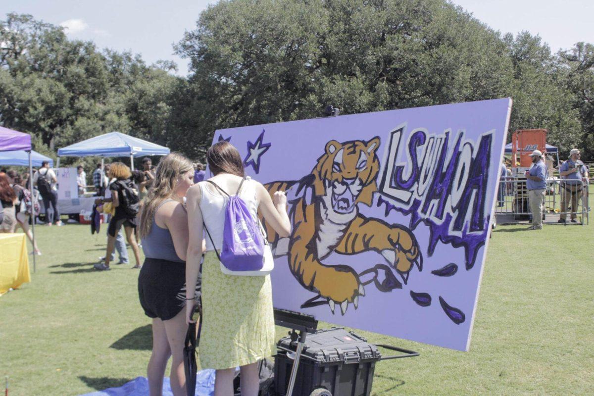 A painter paints a Tiger for the LSU Museum of Art on Friday, Sept. 16, 2022 during Fall Fest on the LSU Parade Ground.