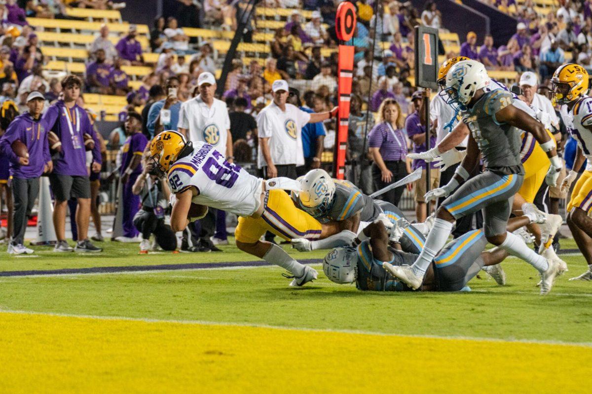 LSU football junior tight end Jack Mashburn (82) drags Southern players toward the endzone on Saturday, Sept. 10, 2022, during LSU&#8217;s 65-17 win over Southern at Tiger Stadium in Baton Rouge, La.