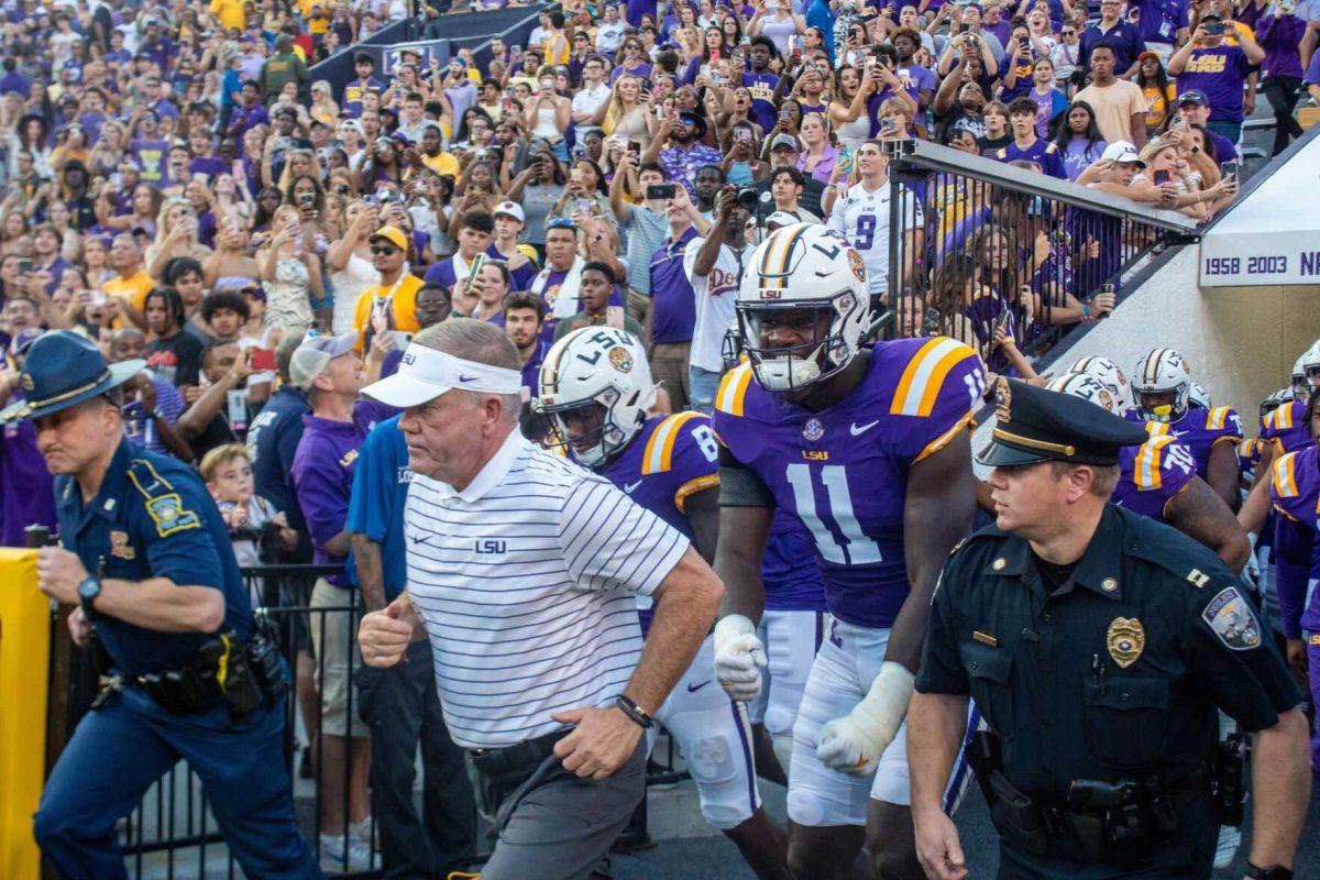 LSU football head coach Brian Kelly and the LSU Football team run out onto the field on Saturday, Sept. 24, 2022, right before the LSU vs New Mexico game starts in Tiger Stadium.