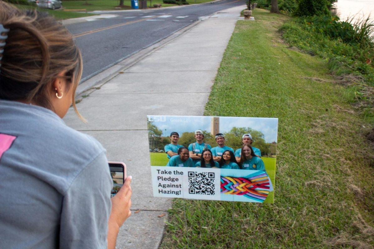 Student scans QR codes during Take a Walk and Take the Pledge event on Friday, Sept. 23, 2022, on W Lakeshore Drive in Baton Rouge, La.