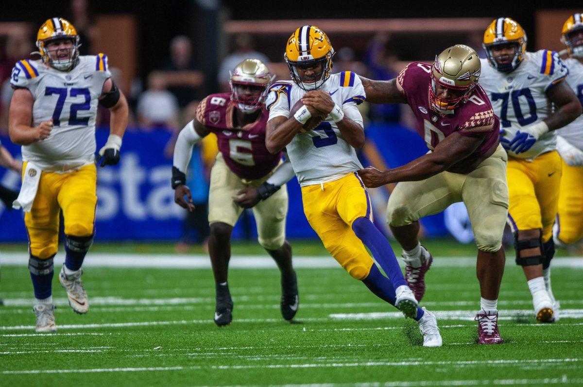 LSU football junior quarterback Jayden Daniels (5) runs with the ball Sunday, Sept. 4, 2022, during LSU's Allstate Kickoff game defeat to Florida State 23-24 in the Caesars Superdome, New Orleans, La.