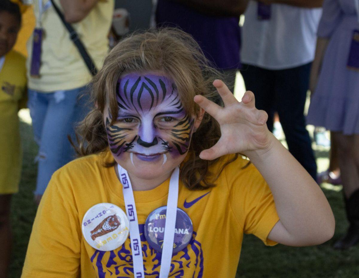 A girl poses with her tiger face paint at the LSU Family Weekend Tailgate on Saturday, Sept. 24, 2022, on the LSU Parade Ground in Baton Rouge, La.