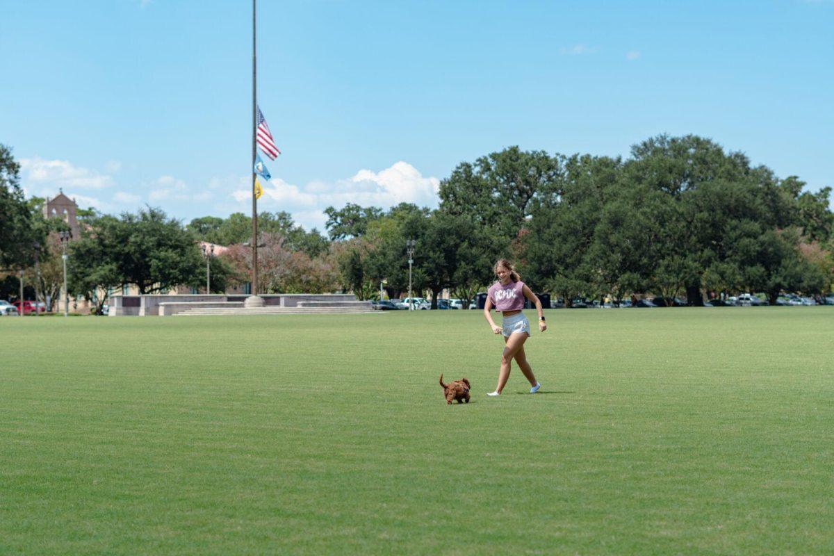 Cooper the dog runs to his owner LSU kinesiology senior Caitlin Mathes on Friday, Sept. 9, 2022, on the Parade Ground on Highland Road in Baton Rouge, La.