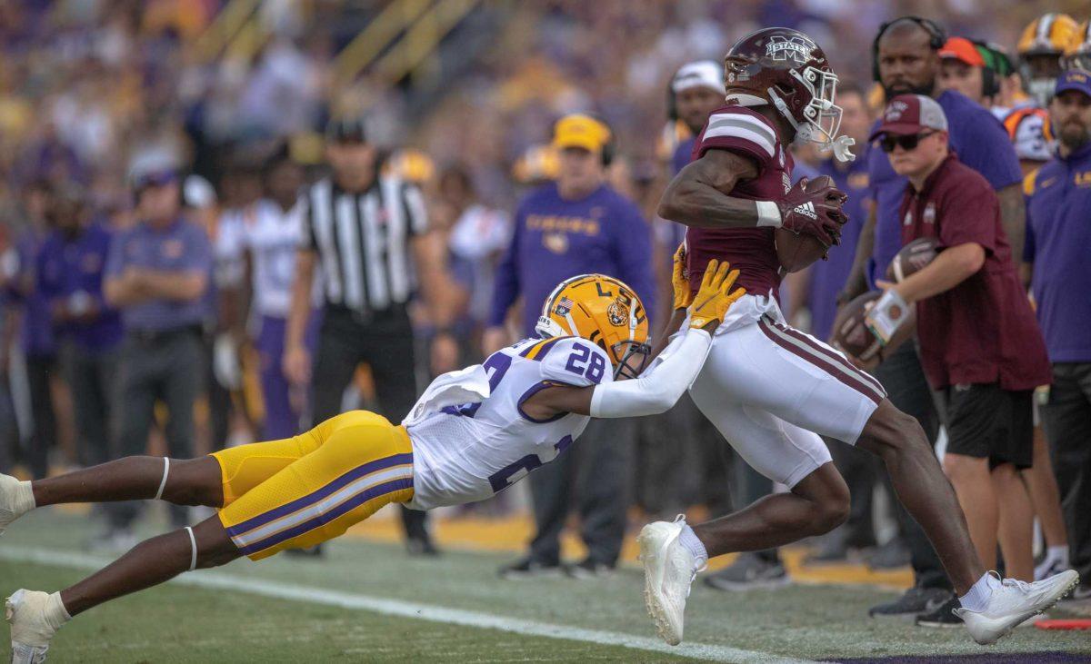 LSU football sophomore safety Major Burns (28) pushes a Mississippi State player out of bounds on Saturday, Sept. 17, 2022, during LSU&#8217;s 31-16 win against Mississippi State in Tiger Stadium in Baton Rouge, La.