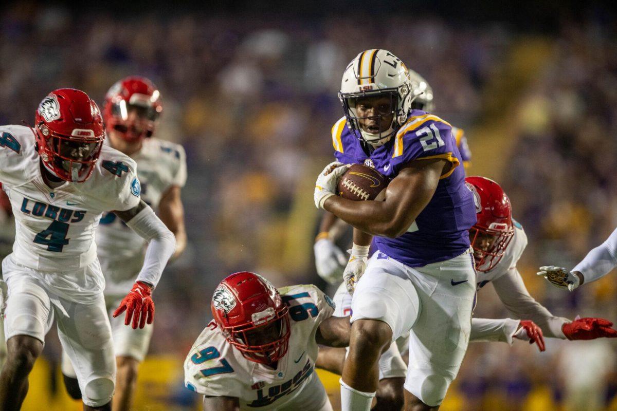 LSU football junior running back Noah Cain (21) dodges being tackled while running the ball on Saturday, Sept. 24, 2022, during the LSU vs New Mexico game in Tiger Stadium&#160;in Baton Rouge, La.