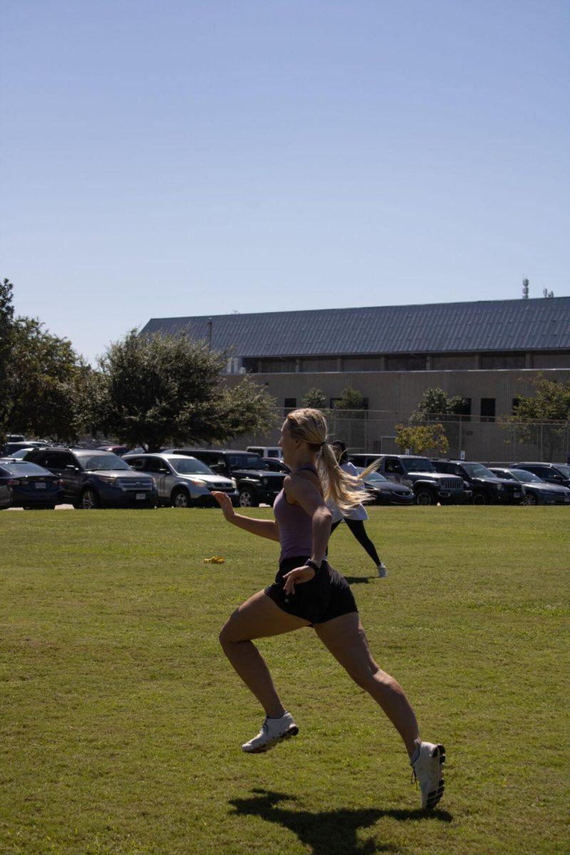 A student runs in a game of capture the flag for jogging class on Wednesday, Sept. 14, 2022, at the field by the LSU Natatorium in Baton Rouge, La.