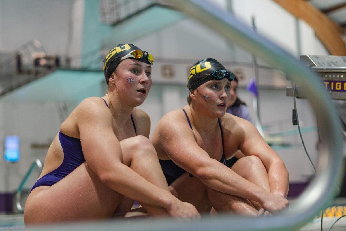 Two LSU swimmers watch the relay after completing their portions on Friday, Sept. 23, 2022, during LSU&#8217;s victory over Tulane and Vanderbilt at the LSU Natatorium on Nicholson Drive in Baton Rouge, La.