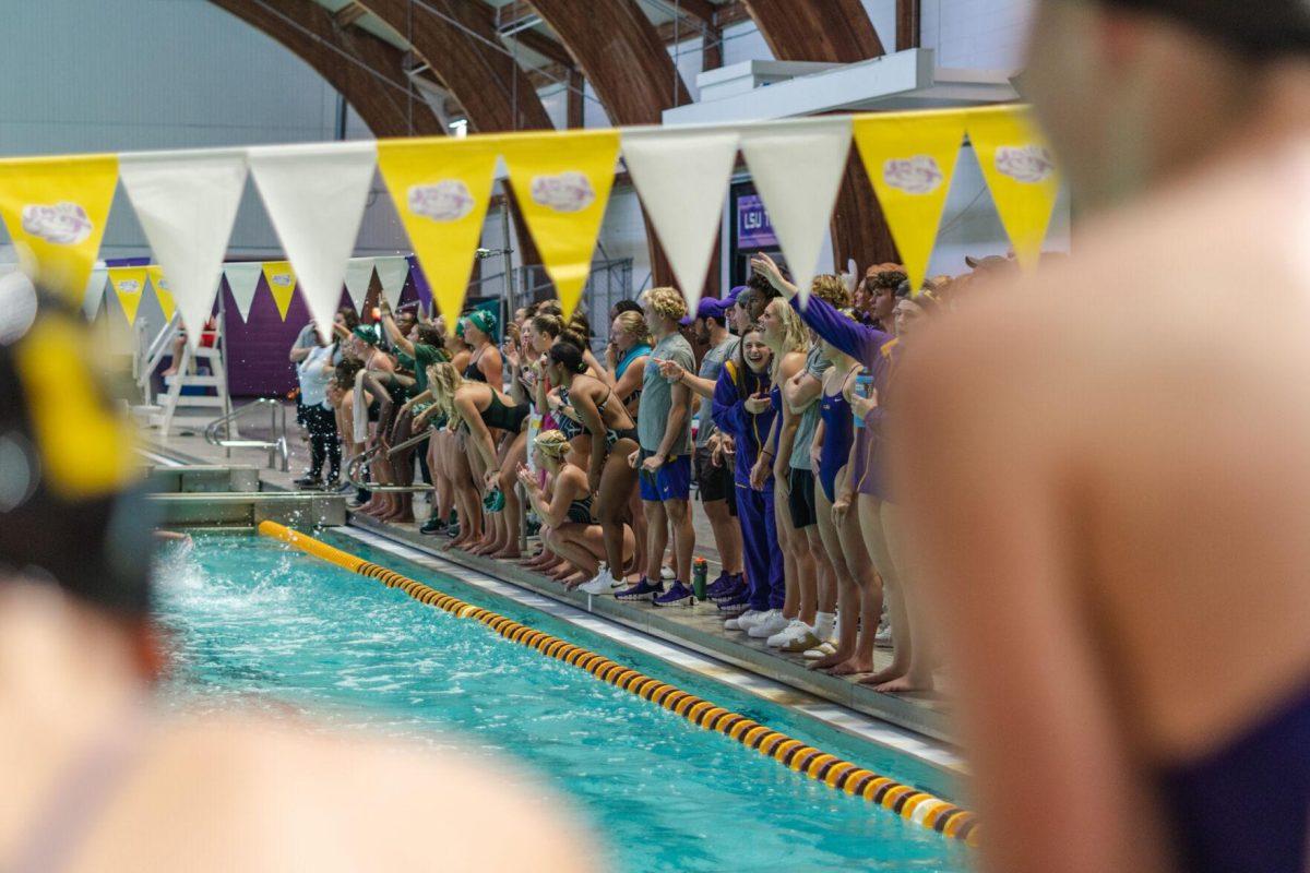 Fellow competitors cheer from the side of the pool on Friday, Sept. 23, 2022, during LSU&#8217;s victory over Tulane and Vanderbilt at the LSU Natatorium on Nicholson Drive in Baton Rouge, La.