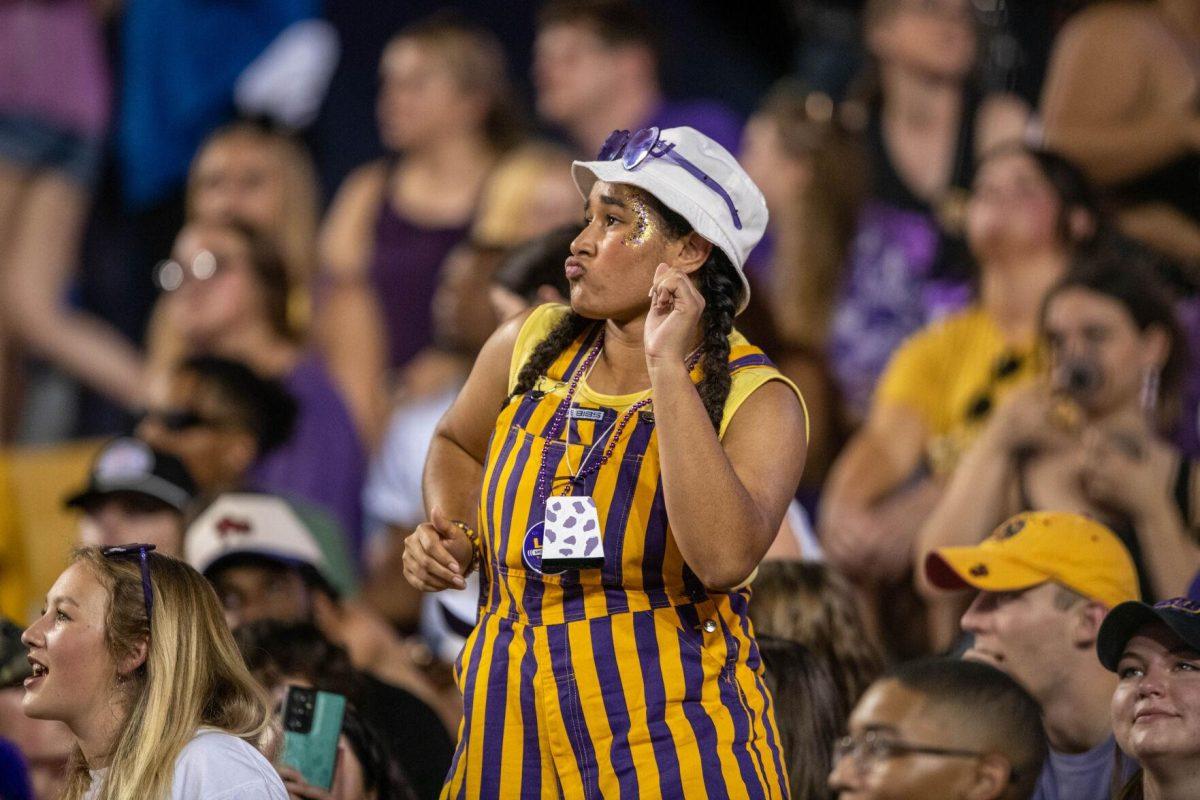 LSU football fan dances from her seat on Saturday, Sept. 24, 2022, during the LSU vs New Mexico game in Tiger Stadium.