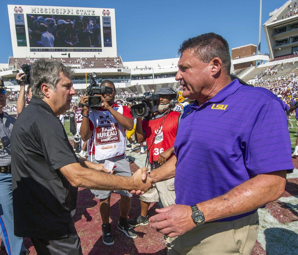 Mississippi State head coach Mike Leach and LSU head coach Ed Orgeron meet at midfield after an NCAA college football game at Davis Wade Stadium ,Saturday Sept. 25, 2021, in Starkville, Miss. LSU won 28-25. (Bill Feig/The Advocate via AP)