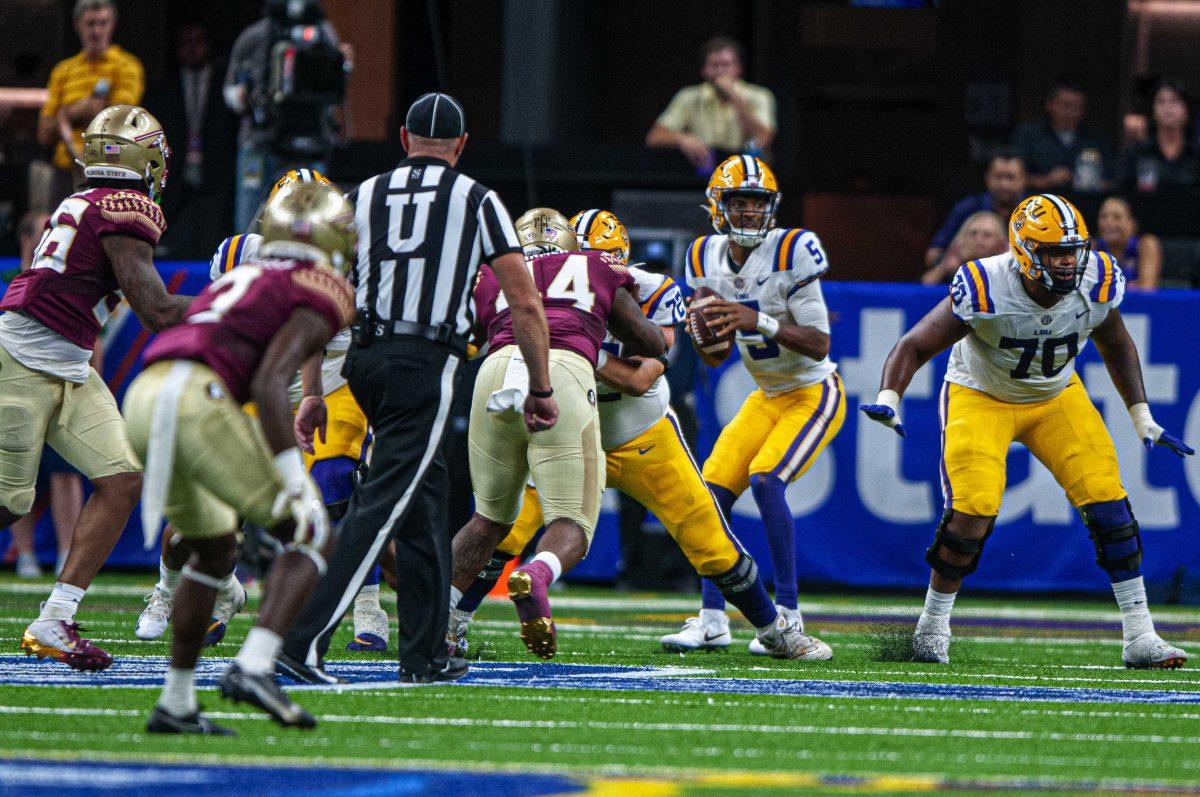 LSU football junior quarterback Jayden Daniels (5) searches for a receiver Sunday, Sept. 4, 2022, during LSU's Allstate Kickoff game defeat to Florida State 23-24 in the Caesars Superdome, New Orleans, La.