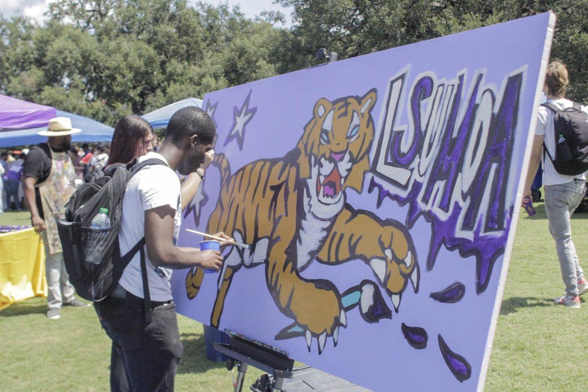 A painter paints a Tiger for the LSU Museum of Art on Friday, Sept. 16, 2022 during Fall Fest on the LSU Parade Ground.