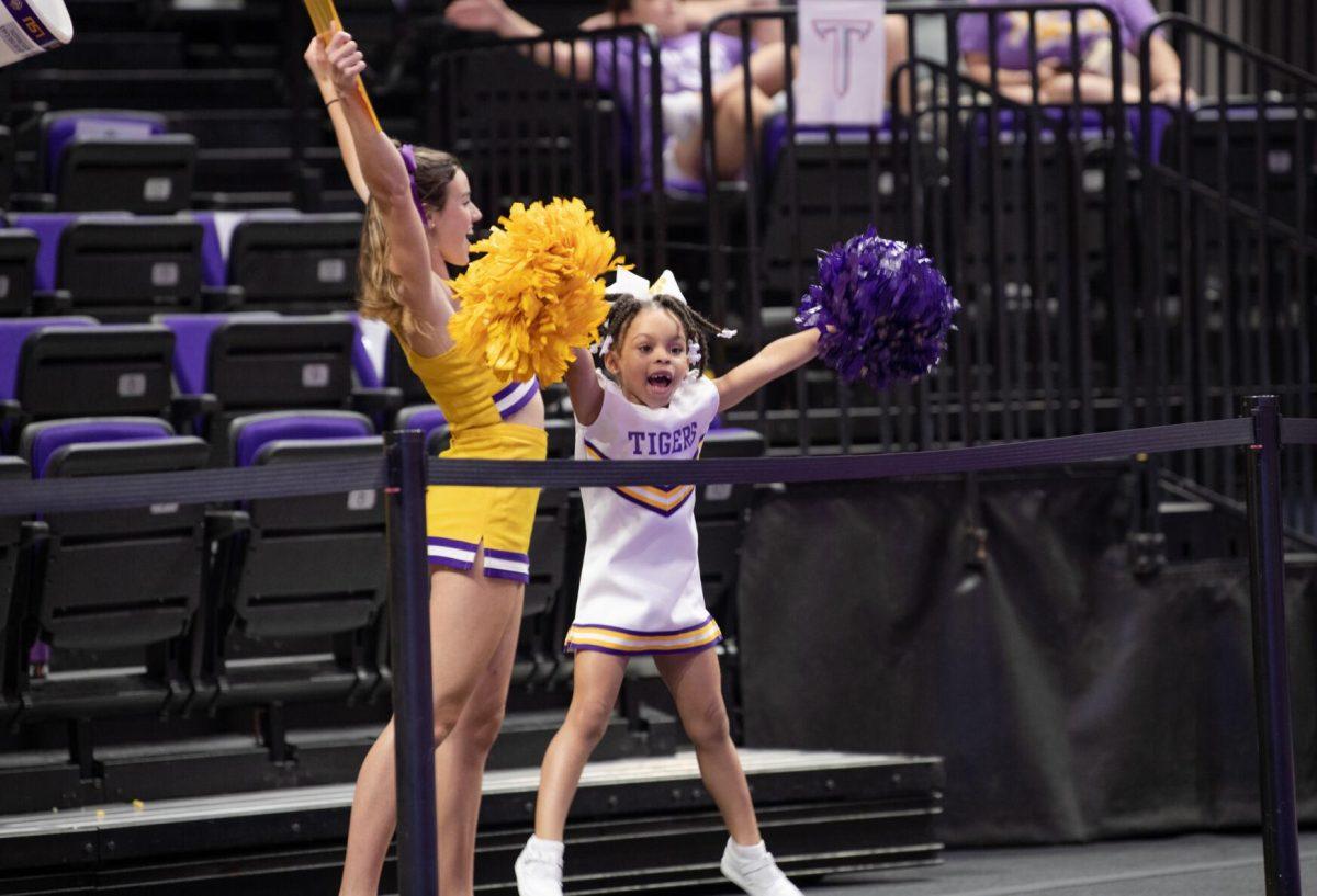 An LSU volleyball fan dressed as an LSU cheerleader jumps on Friday, Sept. 2, 2022, during LSU&#8217;s 3-0 victory over Iowa State in the Pete Maravich Assembly Center in Baton Rouge, La.