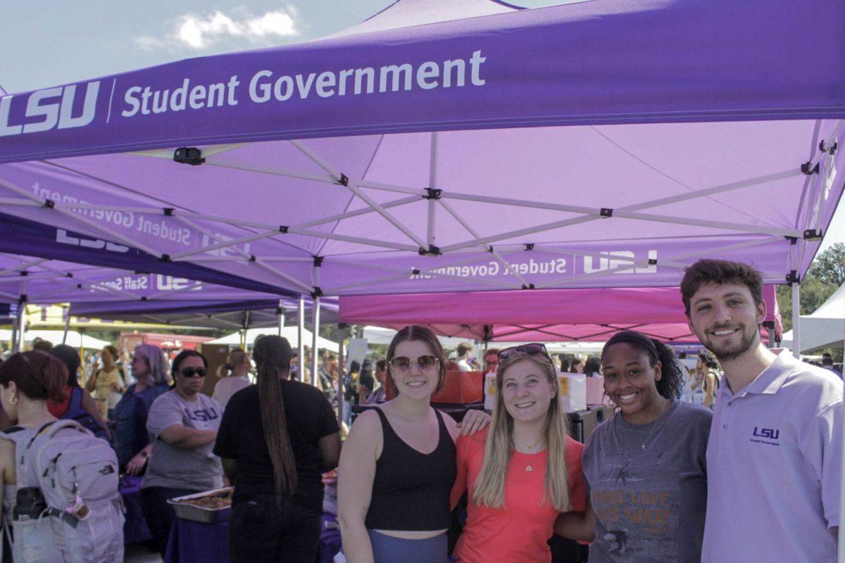 Student Government booth workers pose for a picture during Fall Fest on Friday, Sept. 16, 2022, on the LSU Parade Ground.