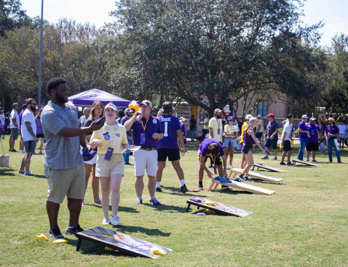 Visitors participate in a cornhole tournament at the LSU Family Weekend Tailgate on Saturday, Sept. 24, 2022, on the LSU Parade Ground in Baton Rouge, La.