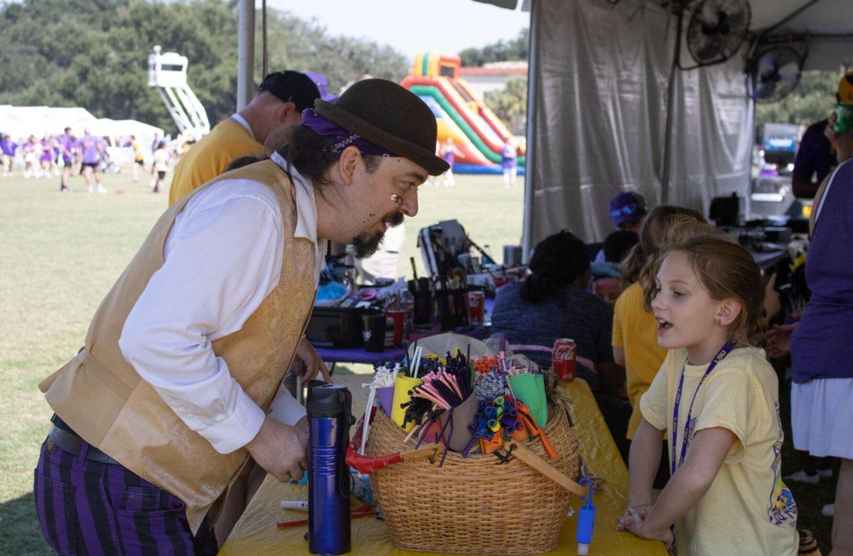 A girl requests a balloon animal at the LSU Family Weekend Tailgate on Saturday, Sept. 24, 2022, on the LSU Parade Ground in Baton Rouge, La.