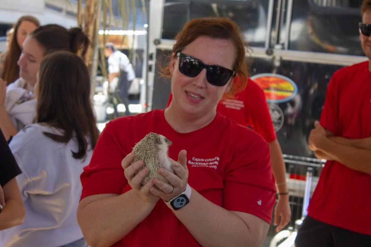 A woman holds a hedgehog on Wednesday, Oct. 5, 2022, on Tower Drive in Baton Rouge, La.